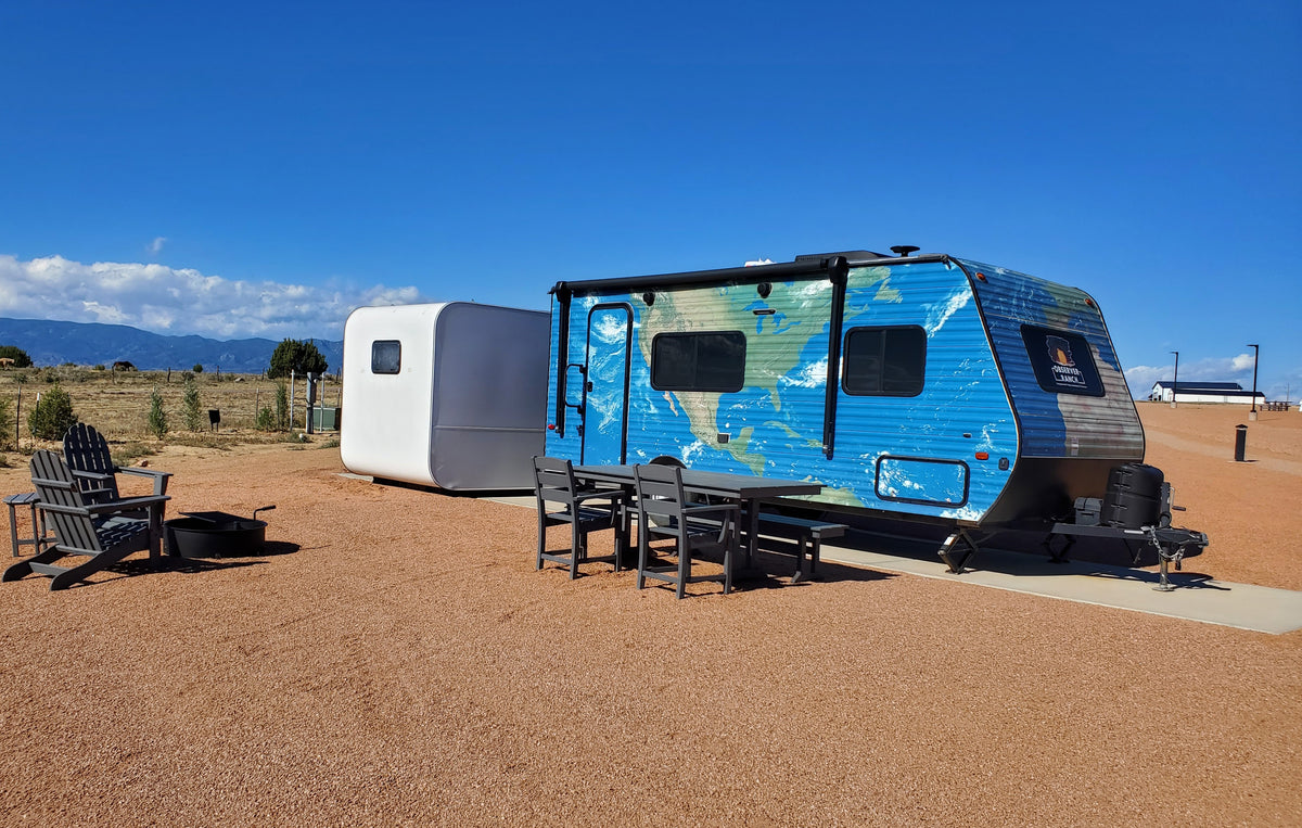 Earth planet camper with blue continents vinyl wrap exterior at Observer Ranch